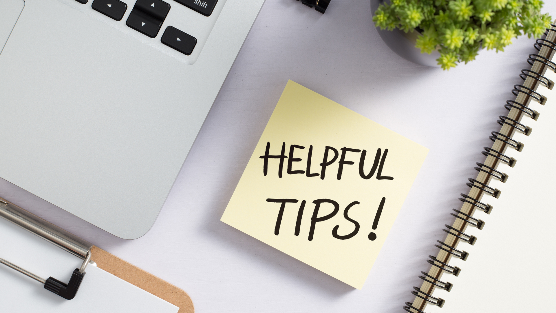 Helpful tips sticky note beside a laptop